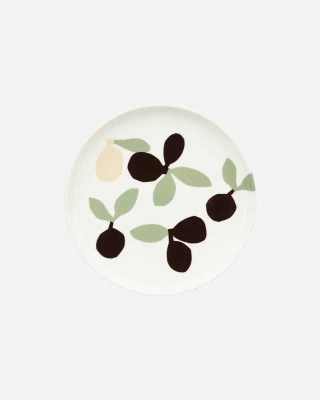 Decorative plate with black and green leaf design on a white background